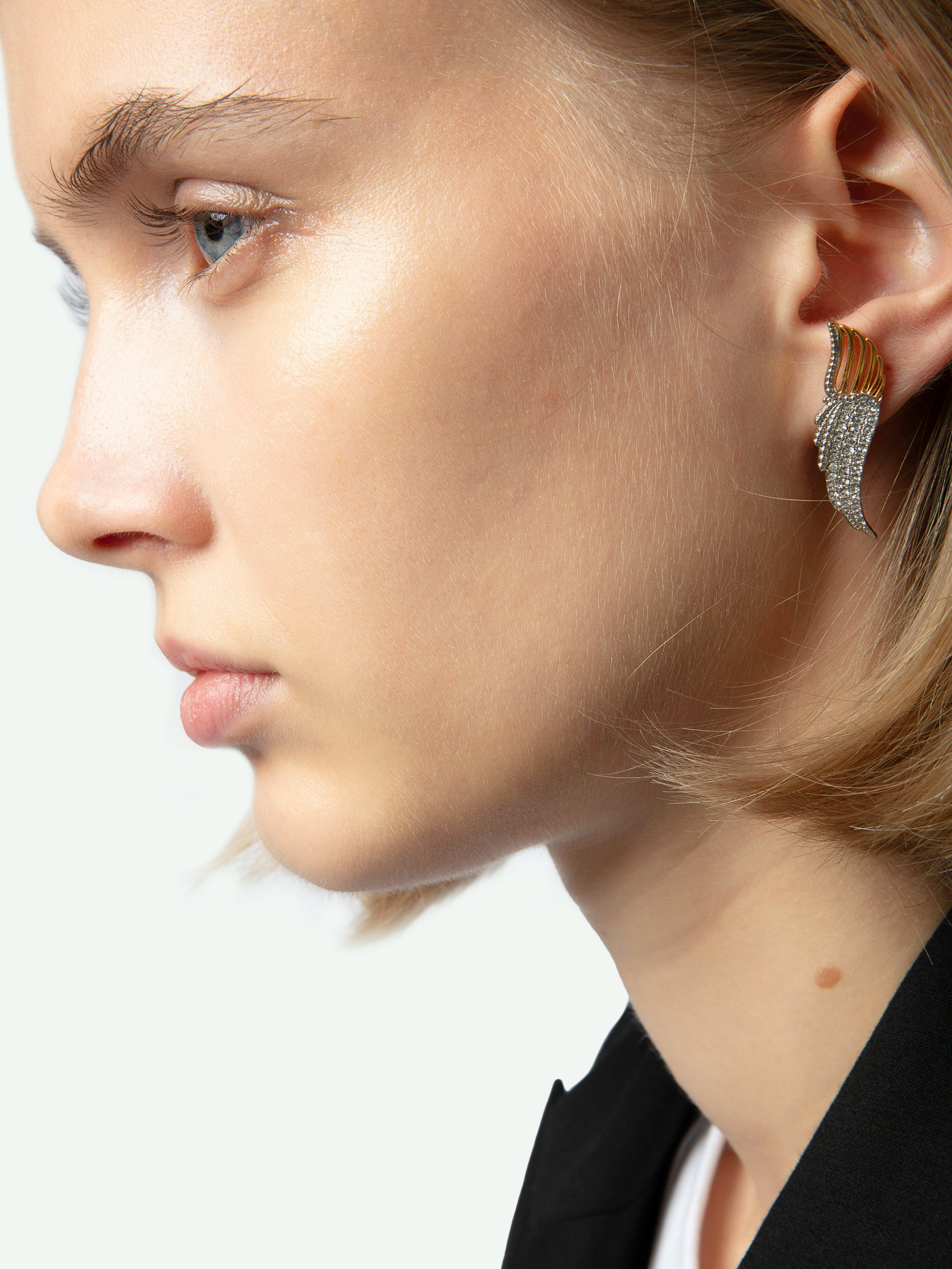 Rock Over Earrings - Wing-shaped earrings in gold-toned metal set with rhinestones.